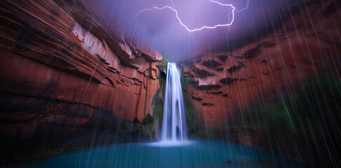 Dramatic waterfall in a red rock canyon during a lightning storm with waterfall © Monir