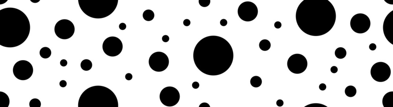 Abstract black polka dot pattern on a white background. Minimalist geometric random circles texture element for modern horizontal banner decoration.