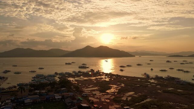 Sunset time lapse over tropical islands near Coron Palawan Philippines with calm sea distant boats golden light and layered mountain silhouettes