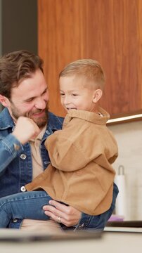 Dad, dancing and boy for smile in kitchen, love and bonding with care with connection in house. Happy people, father and child with rhythm, laugh and tickle with fun, play or excited at family home