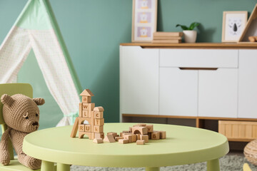 Interior of children's room with table, toys and tent © Pixel-Shot