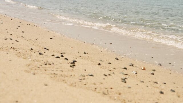 Slow motion behavior of sea waves on a sandy beach in sunny day, Kobe, Japan.