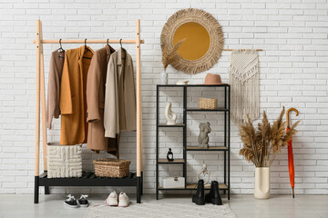 Interior of hallway and rack with stylish clothes