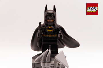 Obraz premium Bologna - Italy - April 2026: Lego batman minifigure character from dc comics universe isolated on a white background standing on a rooftop base.