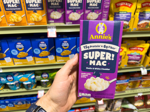 Annie's Super Mac White Cheddar Pasta Box Held in Grocery Store