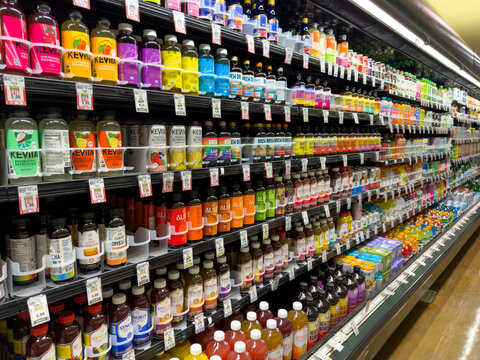 Large Refrigerated Beverage Aisle Display with Assorted Drinks in Grocery Store