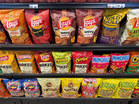 Lay&rsquo;s Cheetos Ruffles and Assorted Snack Chips Bags Display on Grocery Store Shelf