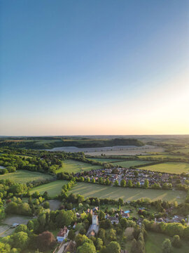 High Angle View of British Countryside and Landscape of Bedfordshire England UK. Drone Camera Footage Was Captured Medium High Altitude During Bright Sunny Day With Blue Sky and Hot Summer Day Over UK