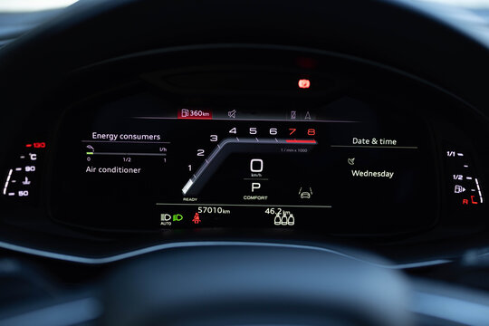 Hybrid car digital display panel. Starting car engine. Tachometer Gauge of Starting and Stopping Car. Many different car dashboard lights illuminated. Petrol meter on black background.