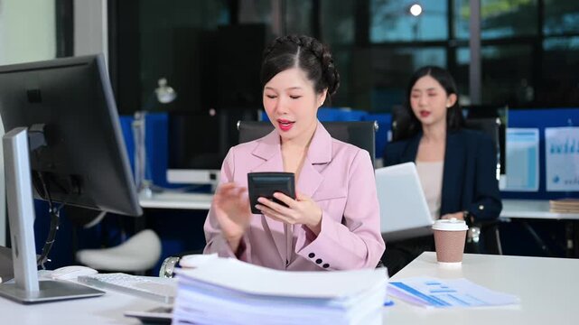  Business woman using tablet and laptop for doing math finance on an office desk, tax, report, accounting, statistics, and analytical research concept in office
