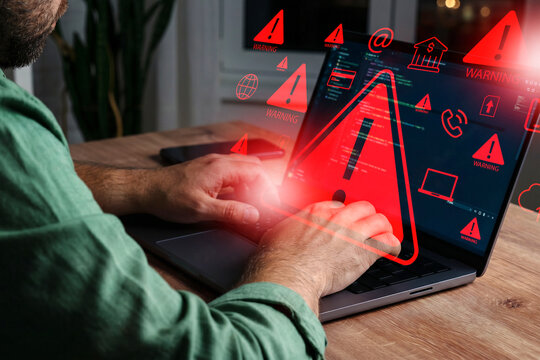 Scam message alert shown on laptop during evening work session