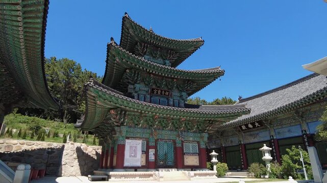 Traditional Korean Buddhist Temple Pavilion with Colorful Dancheong Patterns under Blue Sky