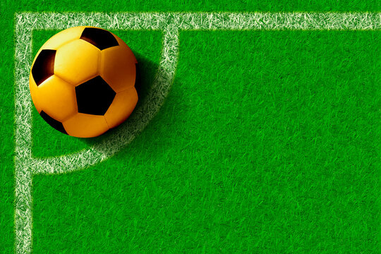 Golden Soccer Ball at Green Grass Field Corner Kick Position