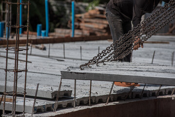 Crane loader for lifting bundles of precast concrete slabs.  © saksuvan
