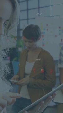 Vertical video: Blonde worker tapping tablet causing red charts while peers comparing business data