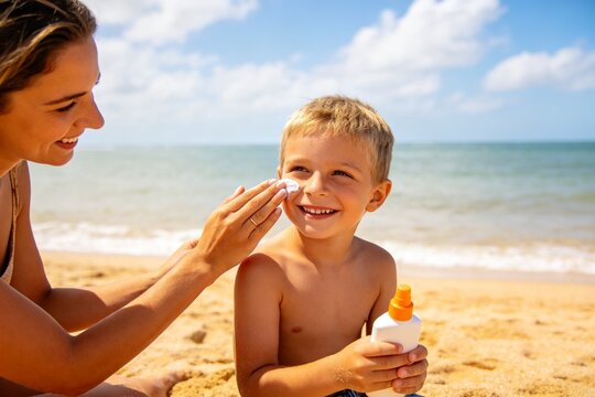 Woman applying sunscreen to child on beach
