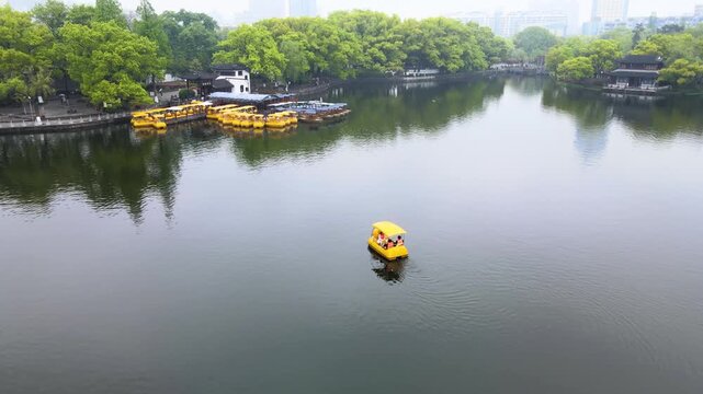 Yellow Pedal Boat on Misty Urban Park Lake