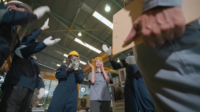 Workplace Chaos: A group of factory workers experiences a moment of panic and confusion amidst industrial machinery, their expressions filled with alarm and surprise.
