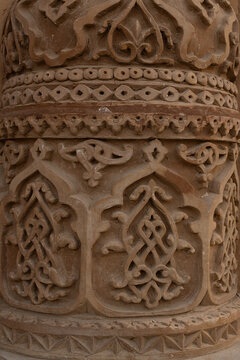 Carved terracotta ganch - ornament detail on the Kalyan Minaret in Bukhara showing intricate floral and geometric patterns. Ideal for use in heritage, architecture, and travel publications.