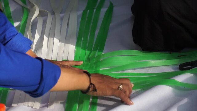 Making woven items using plastic ribbon. Crafts made from recycled materials.