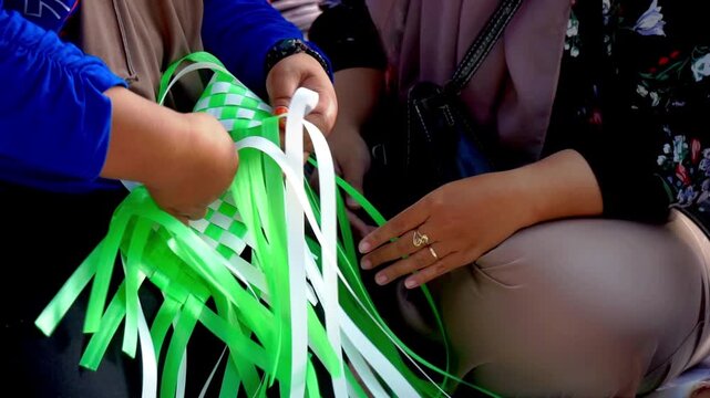Making woven items using plastic ribbon. Crafts made from recycled materials.