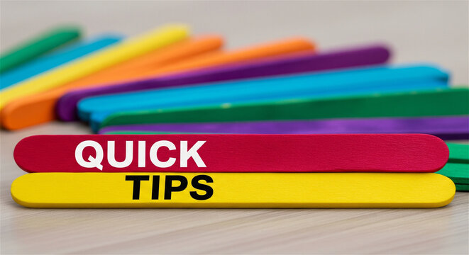 Quick Tips text on colorful wooden sticks, helpful advice and guidance concept, rainbow craft sticks for educational tutorials and life hacks