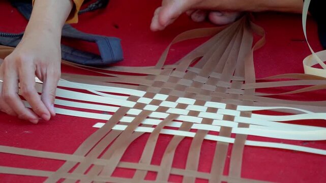 Making woven items using plastic ribbon. Crafts made from recycled materials.