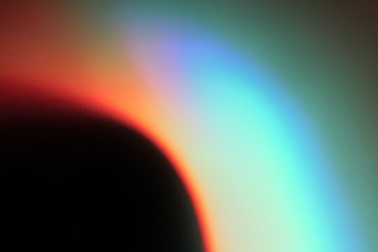 Abstract soft gradient background with vibrant complementary colors blending on a dark backdrop.
