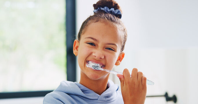 Portrait, toothbrush and smile with kid in bathroom of home for morning routine or oral hygiene. Brushing teeth, cleaning and dental with girl child in apartment for health, prevention or wellness