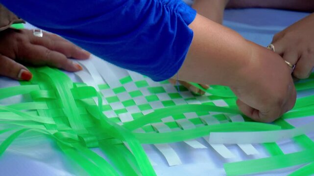 Making woven items using plastic ribbon. Crafts made from recycled materials.