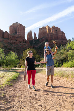 Family of three enjoying views on outdoor hiking trail