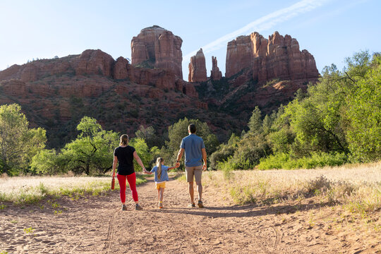 Family of three walking together on wilderness trail