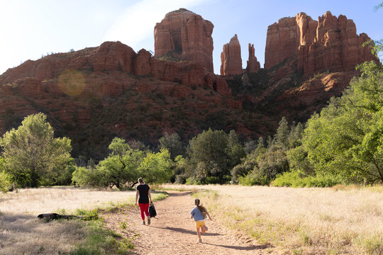 Mother and daughter on nature trail mountainous backdrop