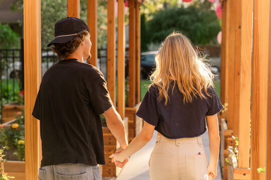 Young couple walking hand in hand outdoors