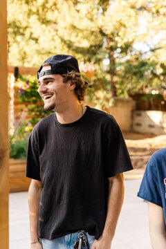 Young man laughing outdoors in afternoon light