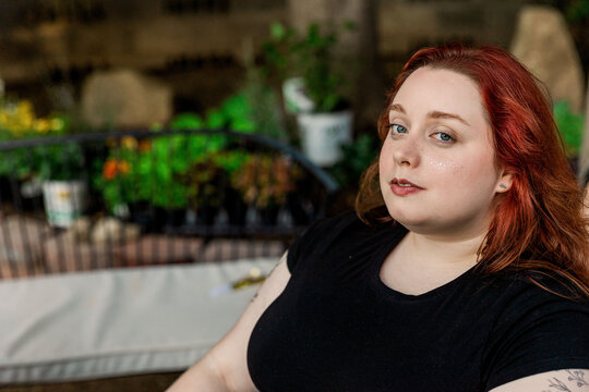 Confident woman relaxing in outdoor garden