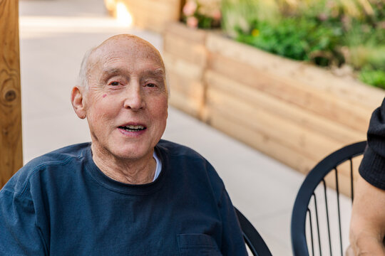Smiling senior man sitting outdoors
