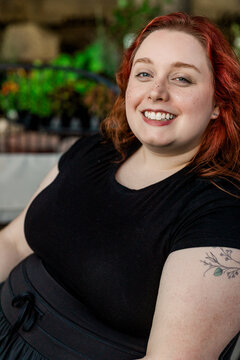 Confident plus size woman smiling outdoors