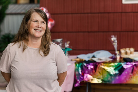 Smiling woman at colorful backyard party