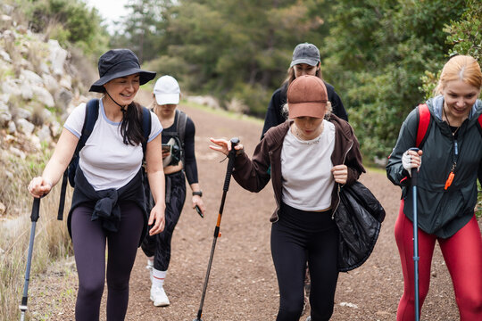 Group of young women hiking on a forest trail