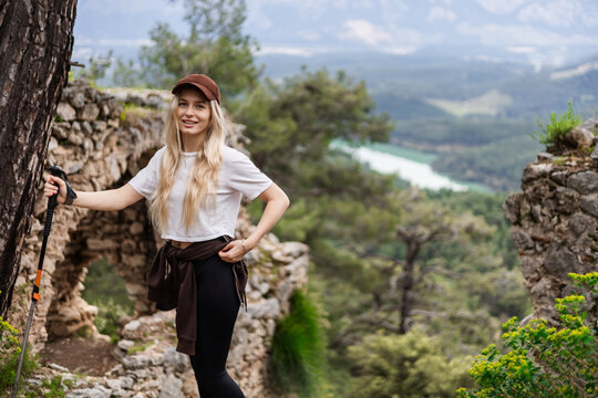 Happy young woman enjoying a scenic mountain hike