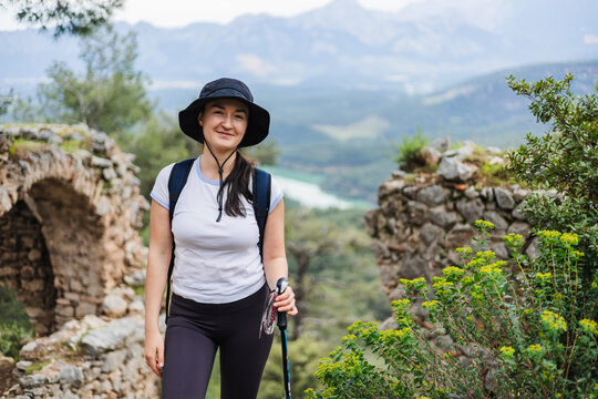 Happy hiker exploring ancient ruins in nature