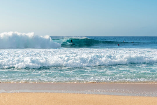 Professional surfer riding a tube wave at Banzai Pipeline