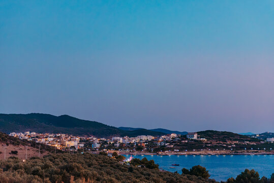 Blue hour view over illuminated Ksamil coastline in Albania