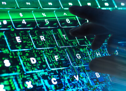 Hand typing on illuminated AI keyboard in cybersecurity concept