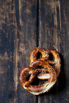 Two pretzels on dark wood