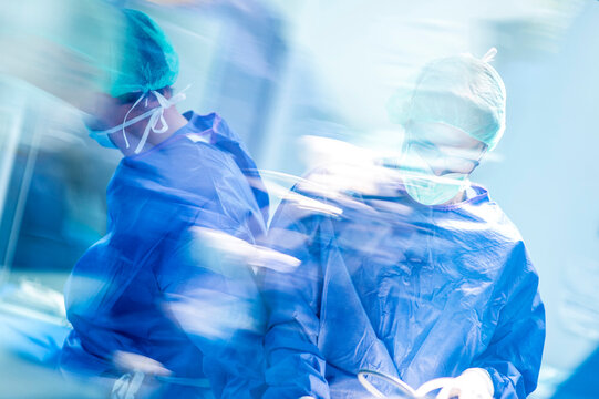Male doctors doing surgery in operating room at hospital