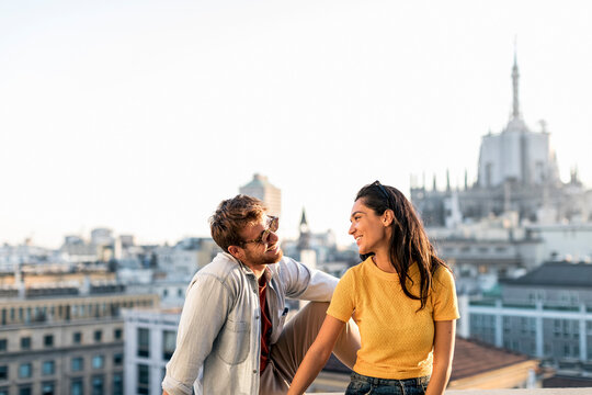Happy young couple above the city, Milan, Italy