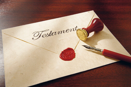 Close up of last will with testament seal and feather pen