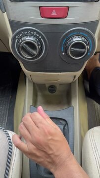Hand shifting manual car gears sequentially from neutral to fifth gear